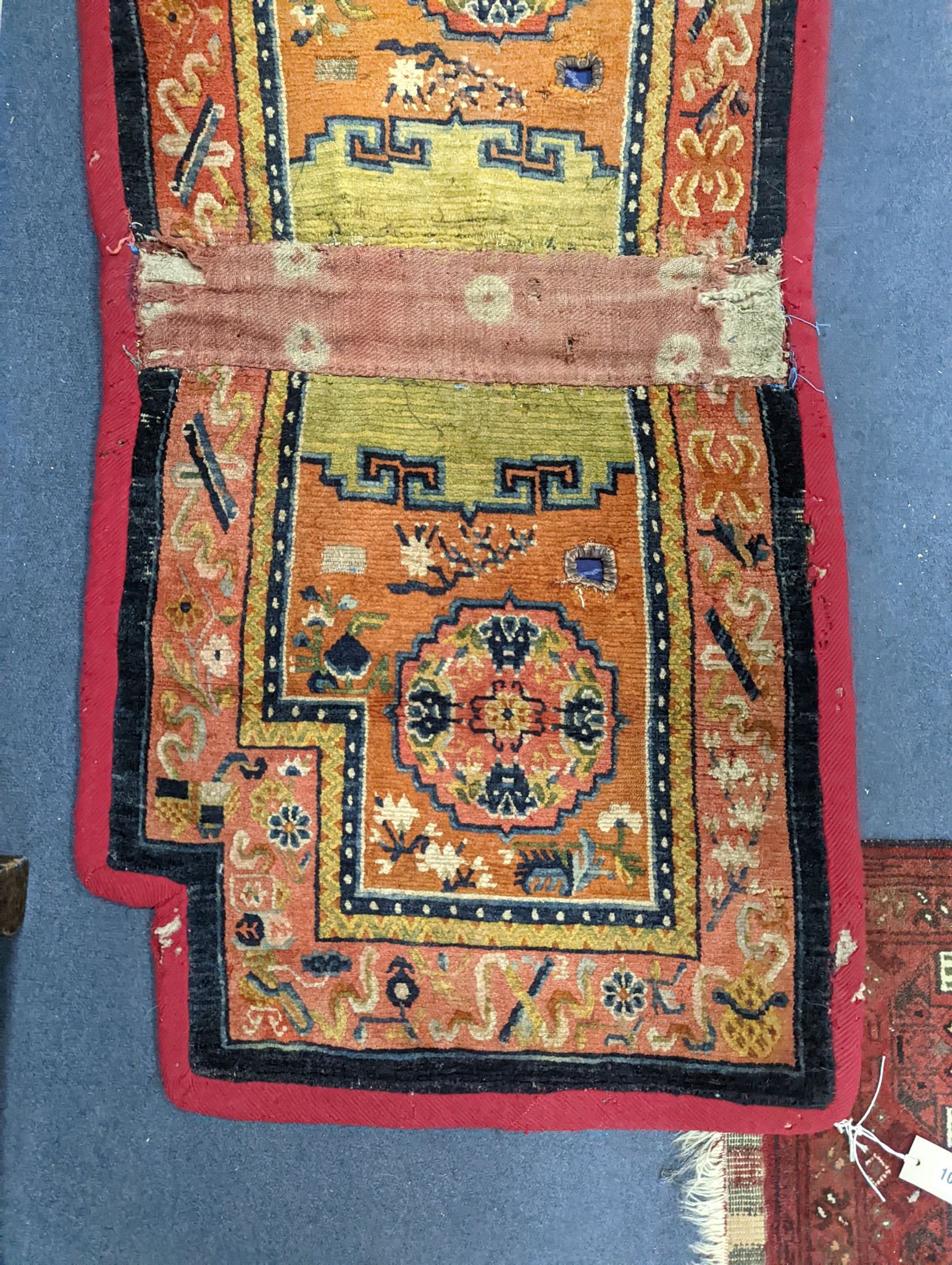 An antique Tibetan saddle cover, 132 x 64cm